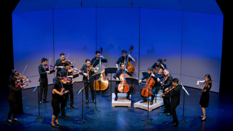 Kinetic ensemble string players performing