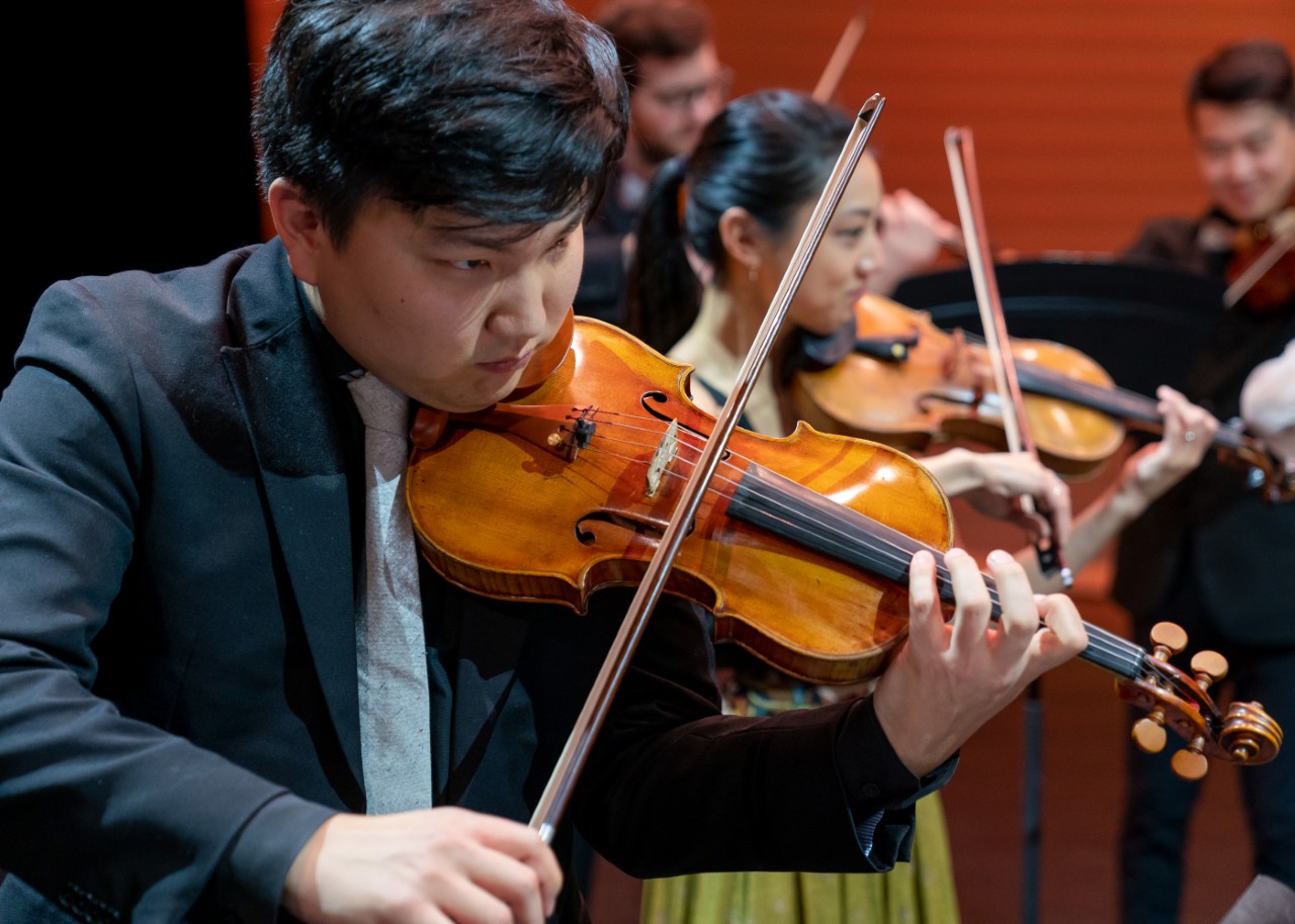 violinists playing music 